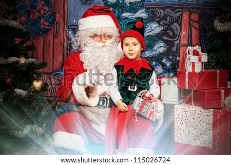 Santa Claus sitting with a little cute boy elf over Christmas background.