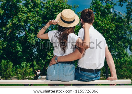 Happy young people in love in the park on a sunny summer day. Summer holidays. Love concept.