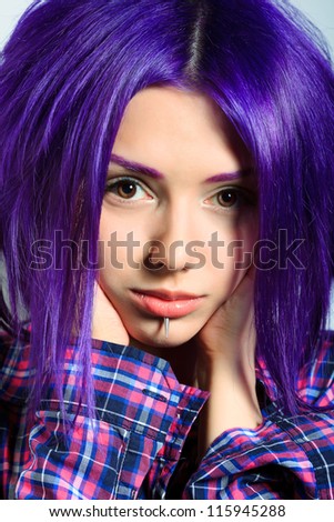 Portrait of a punk girl with purple hair.