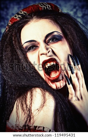 Close-up portrait of a bloodthirsty female vampire.