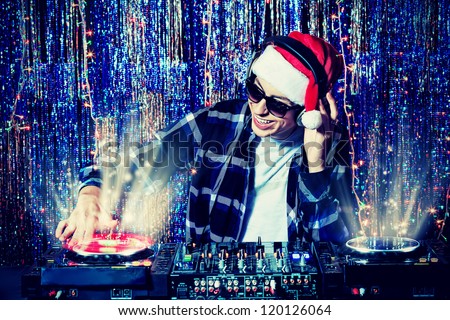 DJ man mixing up some Christmas cheer. Disco lights in the background.