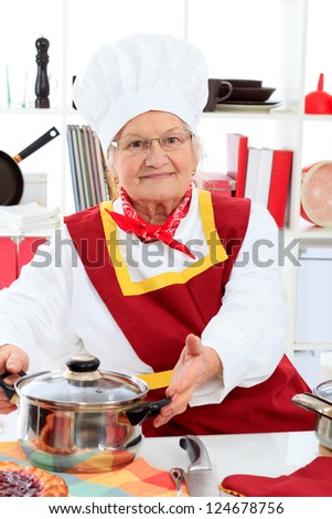 Senior woman chef cooks in the kitchen.