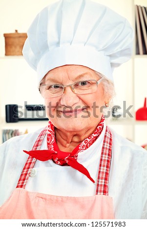 Portrait of a senior woman chef cook in the kitchen.