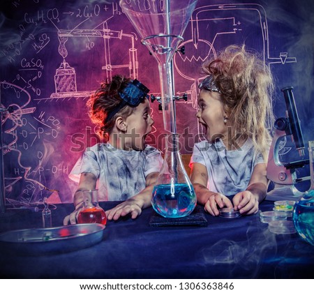 Funny school children doing experiments in the laboratory. Explosion in the laboratory. Science and education.