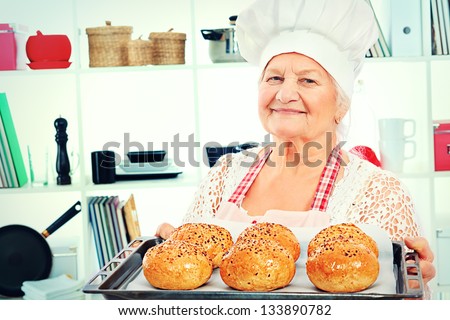 Senior woman chef cooks in the kitchen.