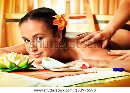 Beautiful young woman taking spa treatments at the salon.