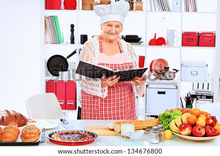 Senior woman chef cooks in the kitchen.