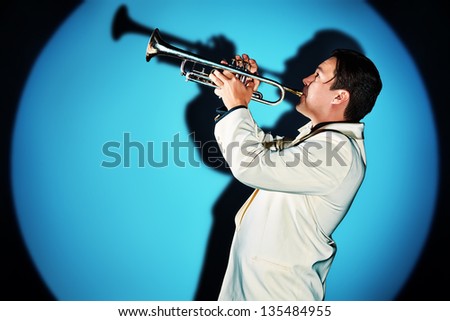 Portrait of a musician playing the trumpet at studio.