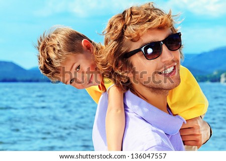 Portrait of a happy father with his little son on vacation.
