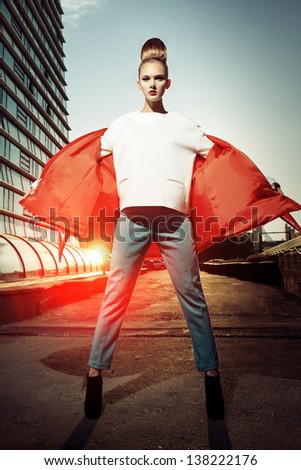 Full length portrait of a fashion model posing over big city background.
