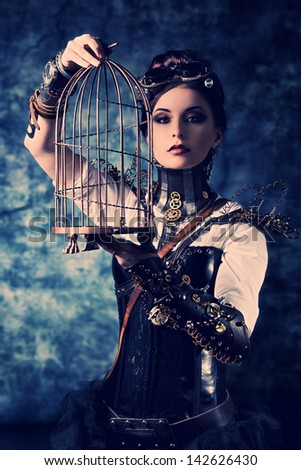 Portrait Of A Beautiful Steampunk Woman With A Cage Over Grunge Background.