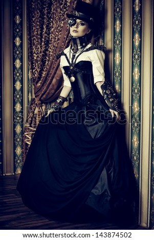 Full length portrait of a beautiful steampunk woman over vintage background.