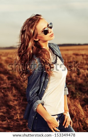 Pretty young woman posing outdoor at sunset Pretty young woman posing outdoor at sunset
