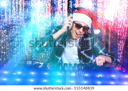 DJ man mixing up some Christmas cheer. Disco lights in the background.