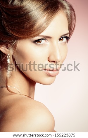 Portrait of a beautiful bride, sweet and sensual. Over pink background.