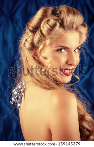 Charming pin-up woman with retro hairstyle and make-up.