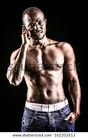 Handsome muscular african american man. Over black background.
