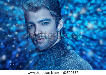 Portrait of a handsome man dressed in winter clothes, covered with frost.