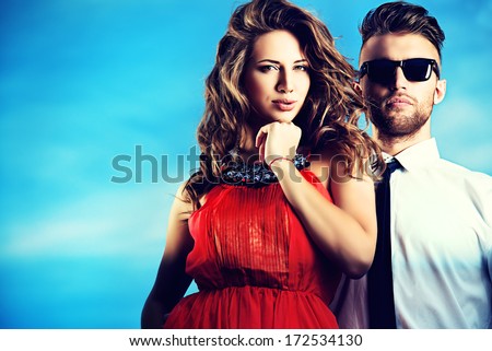 Beautiful Romantic Couple In Love Standing Over Blue Sky.