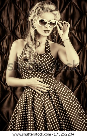 Black-And-White Portrait Of A Charming Pin-Up Woman With Retro Hairstyle And Make-Up.