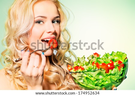 Portrait of a beautiful young woman eating vegetable salad. Healthy life. Diet.