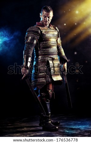 Portrait of a courageous ancient warrior in armour with sword Portrait of a courageous ancient warrior in armour with sword