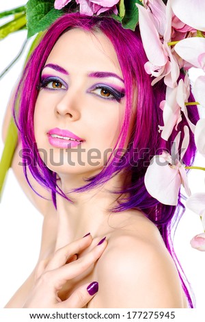 Beautiful woman among the flowers. Spring. Summer. Skin care. Hair coloring. Isolated over white.