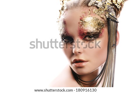 Art project: beautiful woman with golden make-up. Jewelry, make-up. Fashion. Isolated over white.