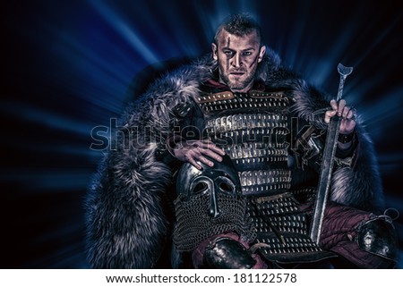 Portrait of a courageous ancient warrior in armor with sword and shield.