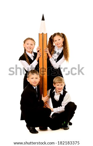 Cheerful schoolgirls and boys stand together and hold a huge pencil Educational concept Isolated over white Cheerful schoolgirls and boys stand together and hold a huge pencil Educational concept Isolated over white