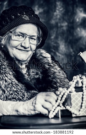 Portrait of a beautiful old lady in an elegant old-fashioned clothes. Vintage style.