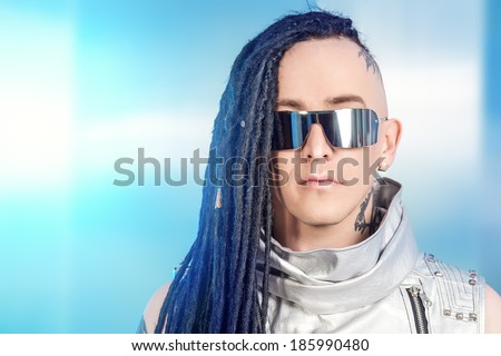 Portrait of the eccentric futuristic man in silver costume. Innovations and high technology. Rock artist.