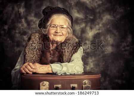 Portrait of a beautiful old lady in an elegant old-fashioned clothes. Vintage style.