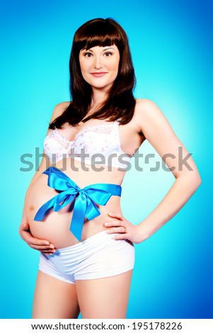 Portrait of a beautiful pregnant woman. Pregnancy. Healthcare. Studio shot.