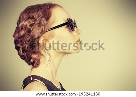 Portrait of a beautiful girl standing in profile. Beauty, fashion, hairstyle.