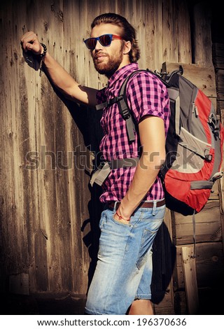 Young man hiking in the countryside. Active lifestyle, tourism.