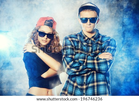 Two modern dancers over grunge background. Hip-hop. Urban, disco style.