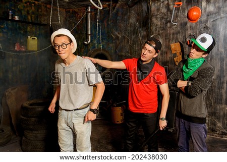Group of cool guys hang out in the garage. Hip-hop style.