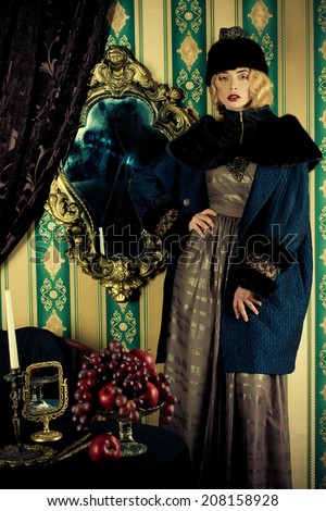 Gorgeous fashion model in a rich historical costume. Fur clothing. Vintage. Luxury style.