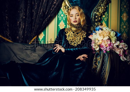 Beautiful fashion model in a rich historical dress. Vintage. Luxury style.