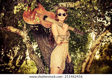 Romantic girl travelling with her guitar. Summer. Hippie style.