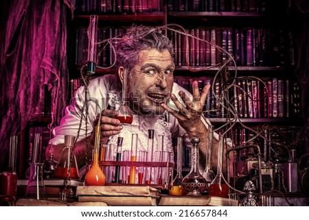 Crazy old man medieval scientist working in his laboratory. Alchemist. Halloween.