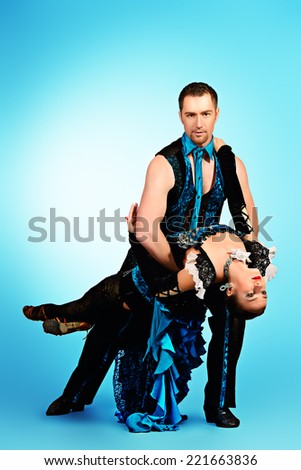 Beautiful professional dancers perform tango dance with passion and expression.