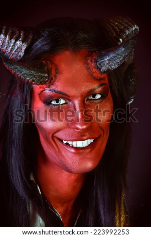 Portrait of a smiling devil with horns. Fantasy. Art project.