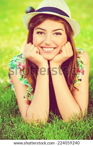 Portrait of romantic young woman with beautiful smile outdoors. Summer day.