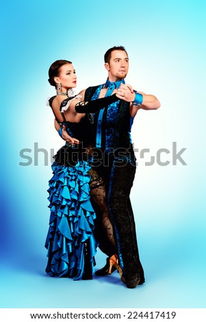 Beautiful professional dancers perform tango dance with passion and expression.