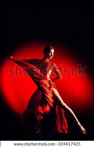 Beautiful professional dancer performs latino dance. Passion and expression.