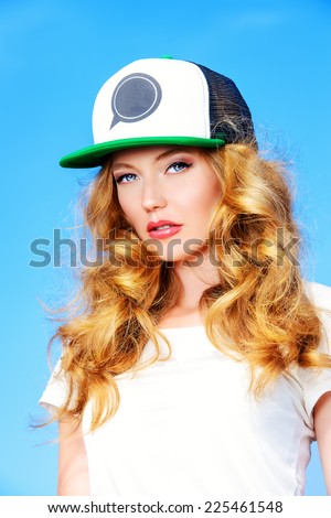 Portrait of a charming girl against the blue sky.
