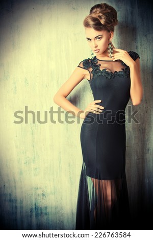 Stunning female model in black evening dress. Fashion shot.