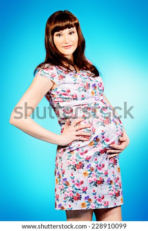 Portrait of a beautiful pregnant woman. Pregnancy. Healthcare. Studio shot.
